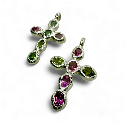 Close-up of Harmony Green and Pink Cross pendants, handmade in Paris from sterling silver with tourmalines.