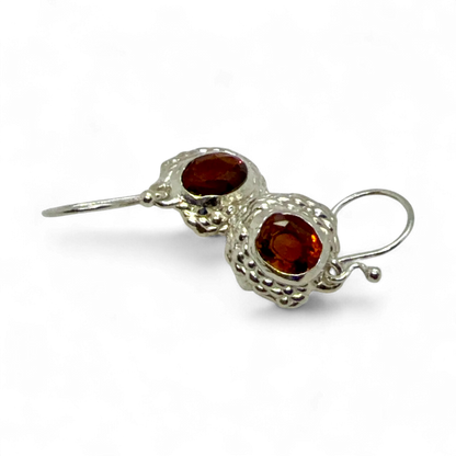 Close-up of Sola Dangles — sterling silver dangle earrings with faceted orange citrine gemstones.
