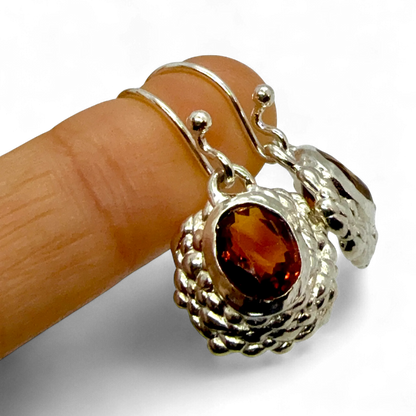 Sola Dangles worn on finger — handmade sterling silver and orange citrine earrings by Lia Makes Jewellery.