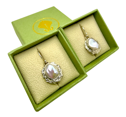 Bulan Dangles resting on Lia Makes Jewellery box — sterling silver and white pearl earrings handmade in Paris.