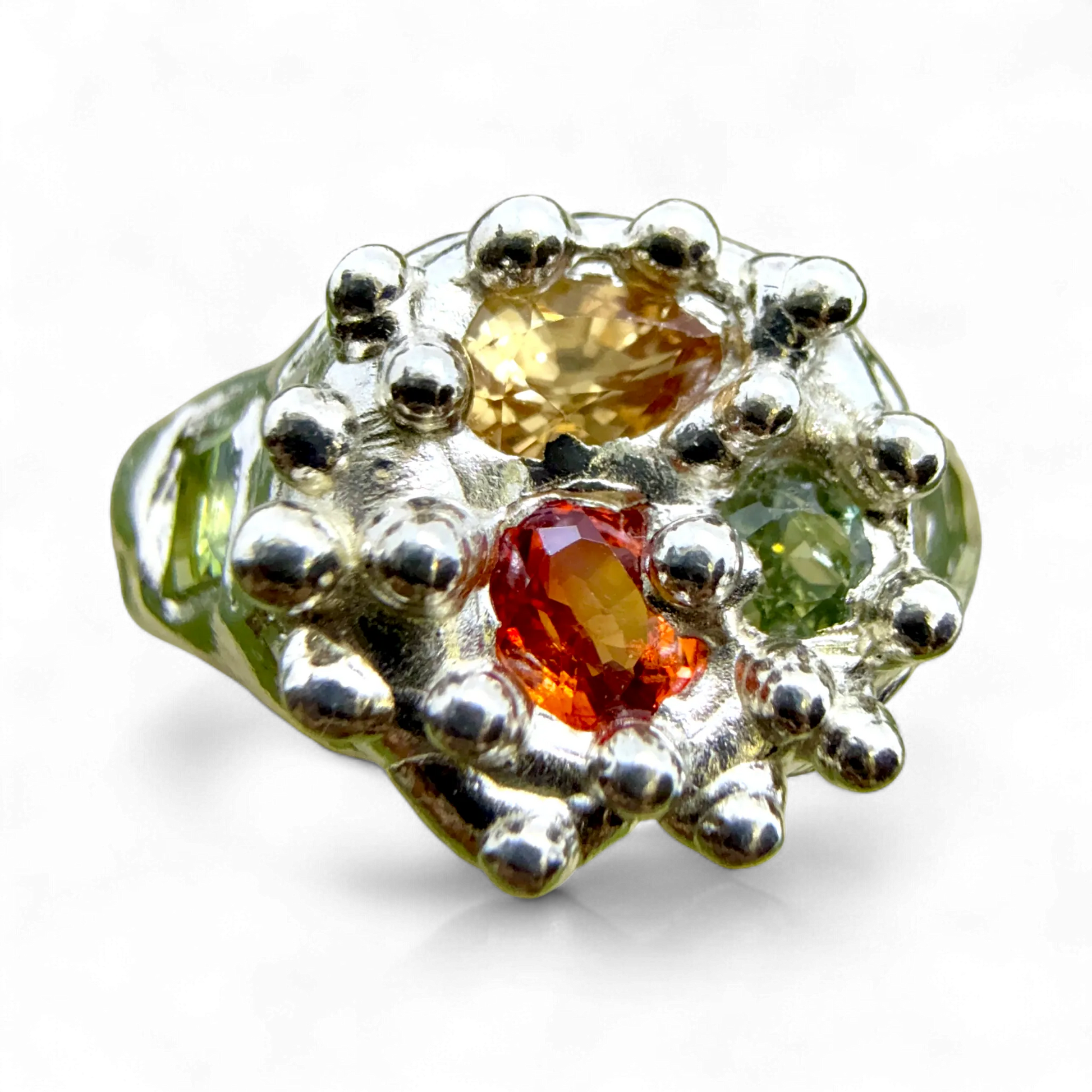 Pijar Ring handmade in Paris by Lia Makes Jewellery — sterling silver ring with yellow, green, and orange sapphires in a sculptural cluster design.