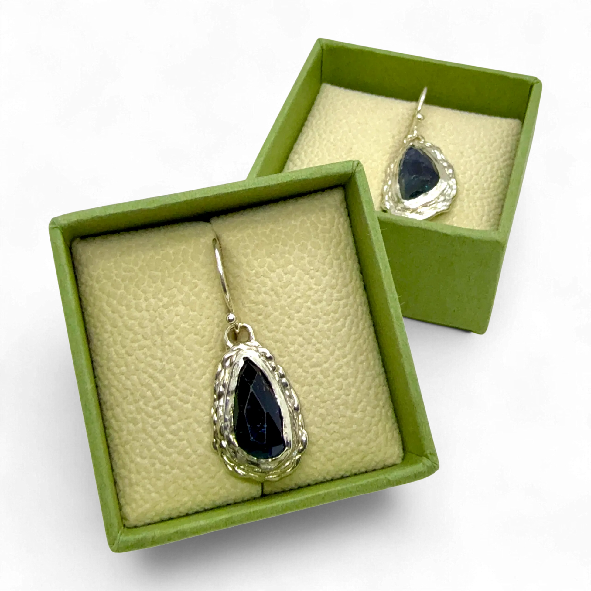 Close-up of Orra Dangles — sterling silver dangle earrings with green-bluish tourmalines, handmade in Paris.