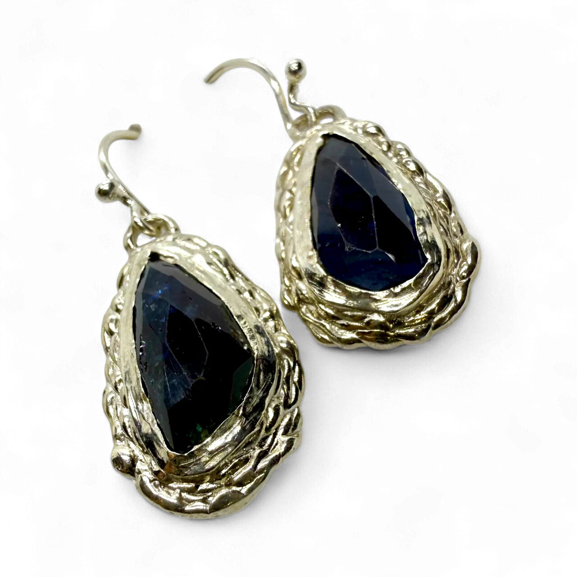 Side view of Orra Dangles showing the fine silver setting and natural green-bluish tourmaline gemstones.