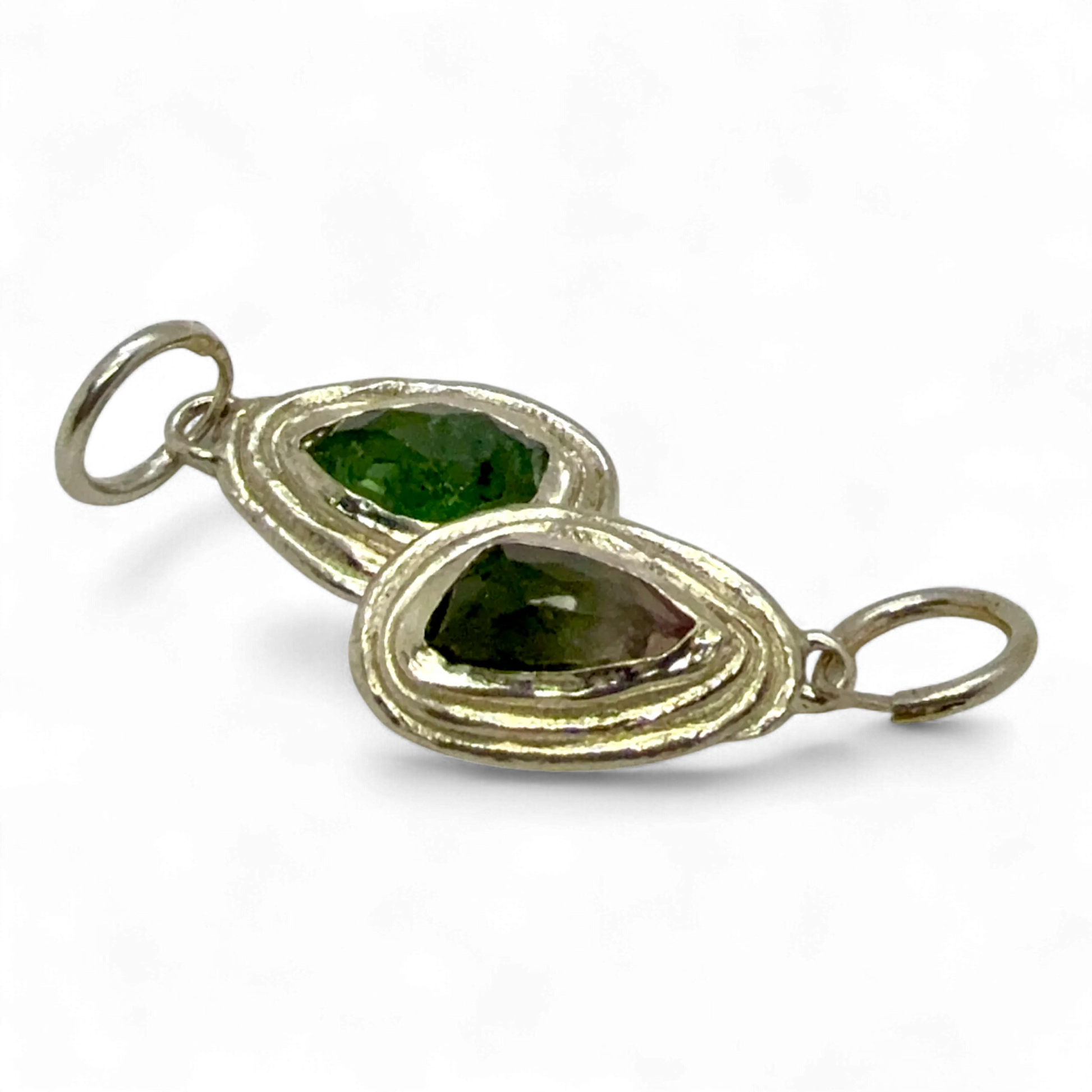 Close-up of Orra Hoops — handmade silver hoop earrings featuring soft pink and green tourmalines.