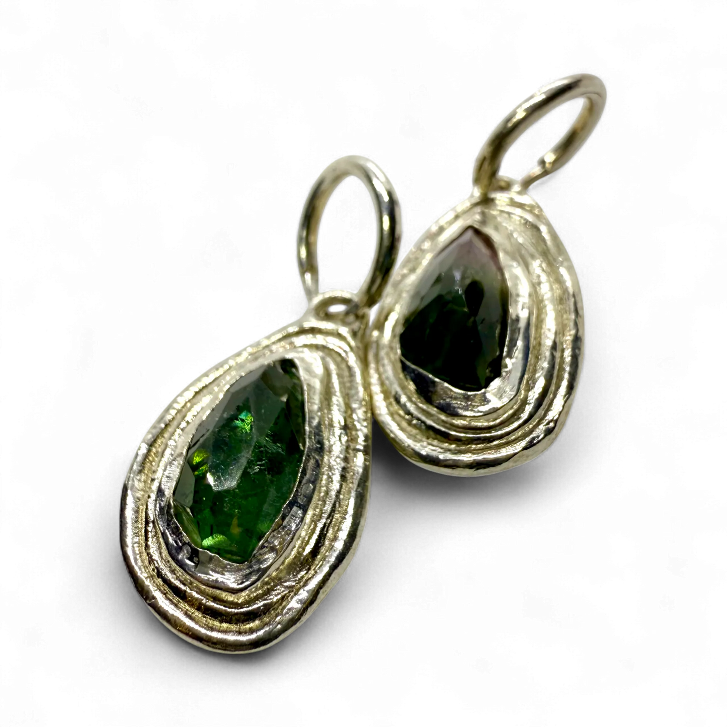 Bright view of Orra Hoops showing subtle green and pink tourmaline tones in polished silver hoops.