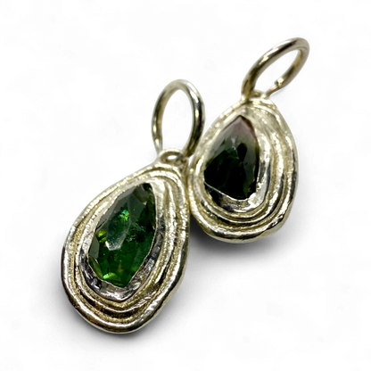 Bright view of Orra Hoops showing subtle green and pink tourmaline tones in polished silver hoops.