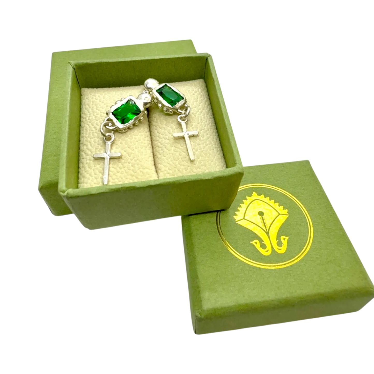 Close-up of Santo Studs highlighting fine silver texture and bright green stones.