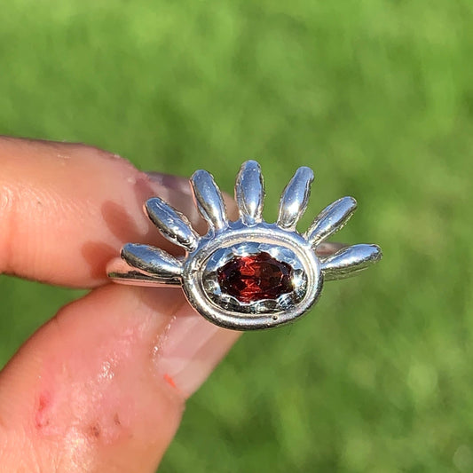 Eyelash ring comes with red garnet in sterling silver band. 