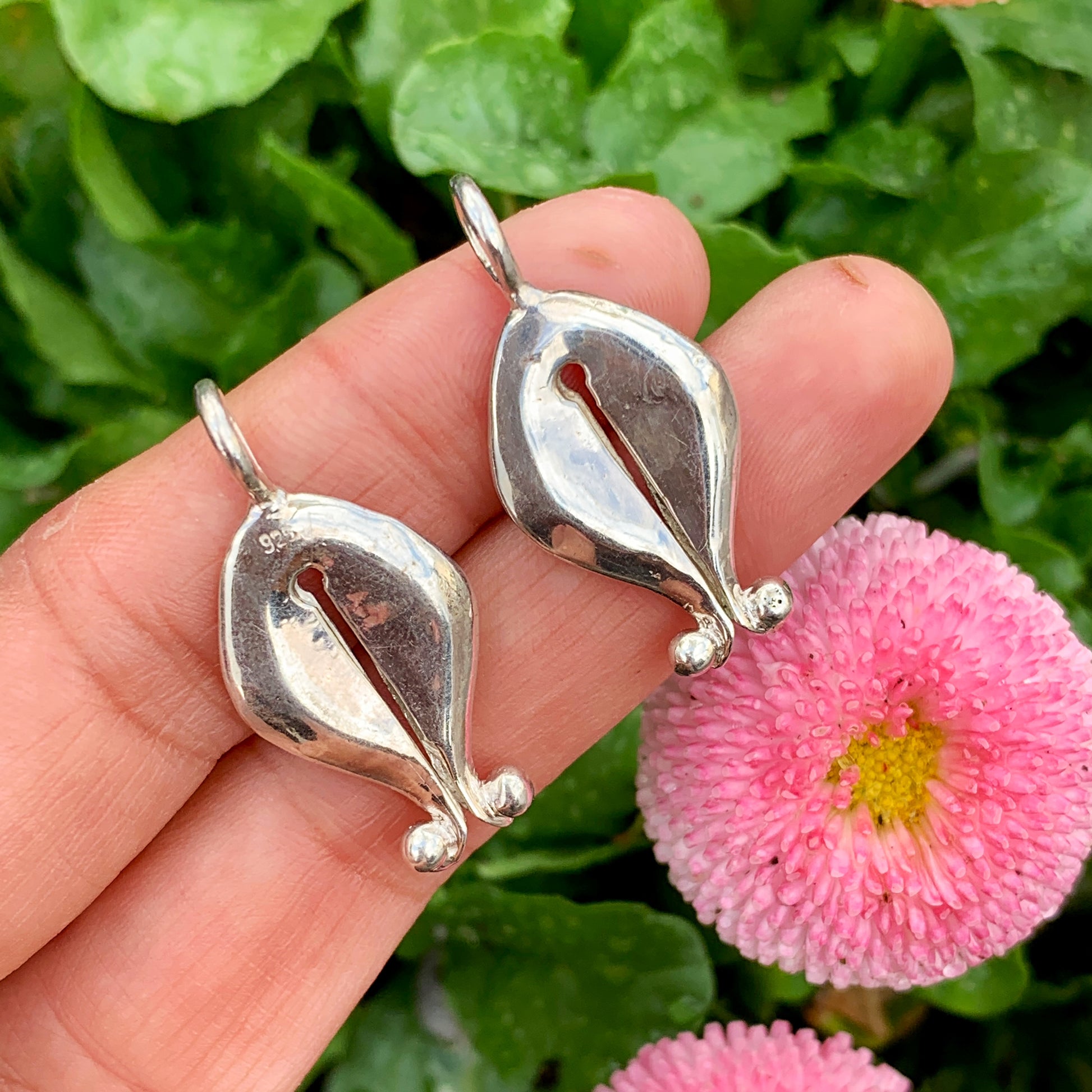 The Gadis pendant, which means "girl" in Bahasa Indonesia, is inspired by Mamuli, a traditional ornament from Sumba Island, Indonesia. In the past, Mamuli was worn by women as a symbol of beauty and status, and sometimes by men. It is designed to resemble female genitalia and is believed to symbolize prosperity, power, and the reproductive power of women. In Sumbanese mythology, Mamuli is also believed to have supernatural power and was used as a good luck charm and to communicate with ancestors.
