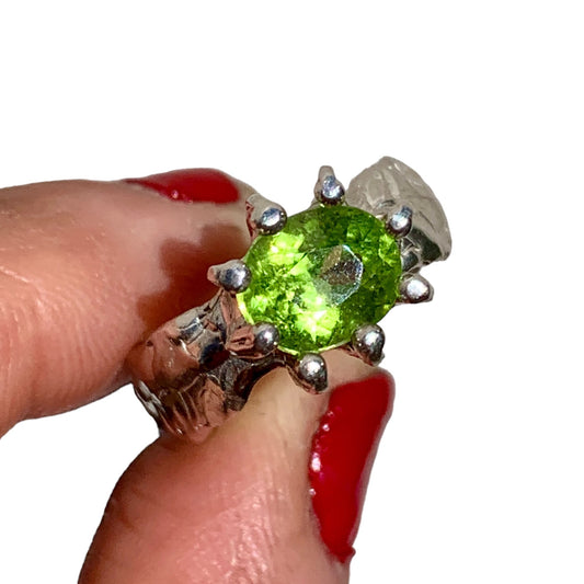 Jungle Queen ring is handmade from sterling silver and features a beautiful green peridot stone securely held in place by silver claws to showcase its captivating colour. It is available in size K 1/2. 