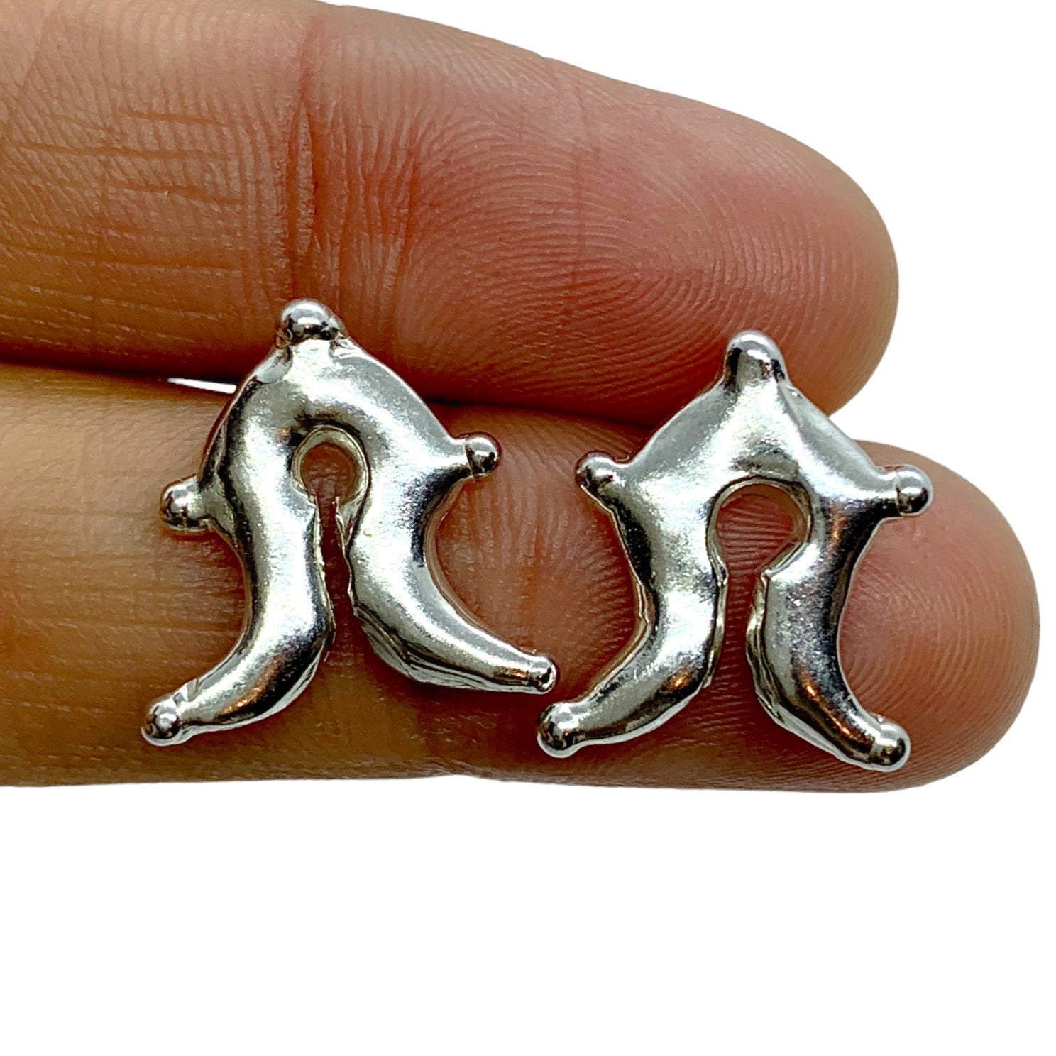 Mamuli are precious metal ornaments of the Sumba people, Sumba, Indonesia.The Mamuli ornaments have a shape which represents the female genitalia, symbolising the woman as the giver of life. The round hole and a slit in the middle is a symbol of woman's sexuality and reproductive power.  