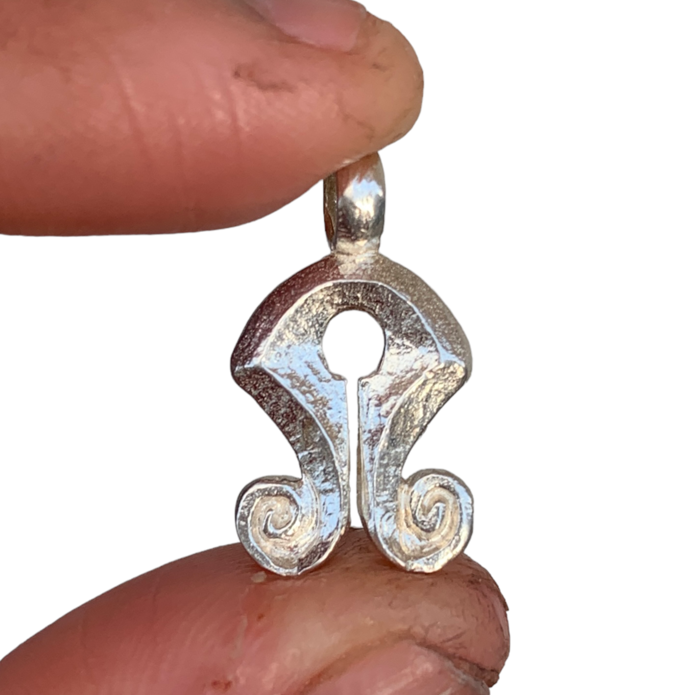 Mamuli is a traditional ornament from Sumba Island, Indonesia. Back in the old days, women ( and sometimes men ) in the Sumba tribe use this as a symbol of status and beauty.  The design of Mamuli resembles female genitalia, which is supposedly a symbol of prosperity and power. The round hole and a slit in the middle is a symbol of woman's sexuality and reproductive power of women as the giver of life.