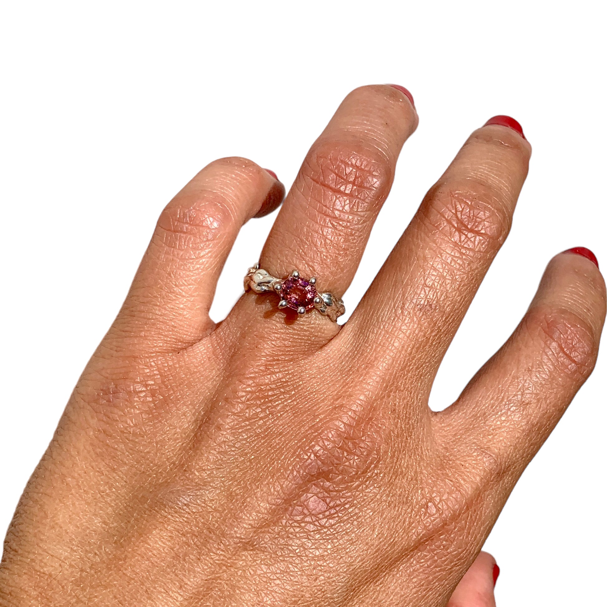 The Rosette ring coms with pink spinel stone. Made with sterling silver and held securely in place by six claws, this ring comes in a size K 1/2 or 5 3/8.