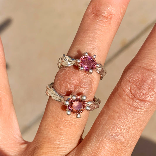 The Rosette ring coms with pink spinel stone. Made with sterling silver and held securely in place by six claws, this ring comes in a size K 1/2 or 5 3/8.